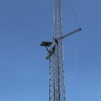 a radio tower with a light attached to it